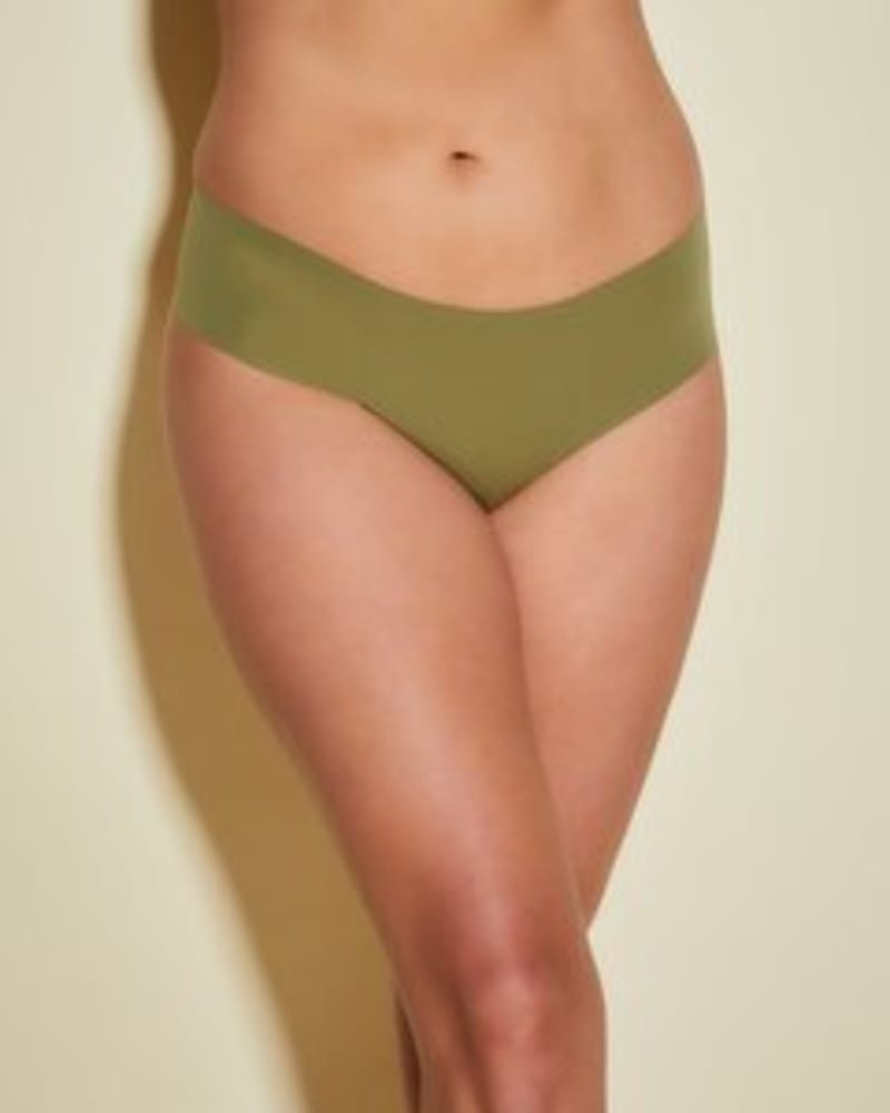Front of a model wearing a size 1X Free Cut Low Rise Thong in Aloe by Cosabella. | dia_product_style_image_id:253592